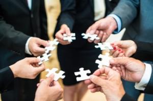 business people hands in circle with puzzle pieces