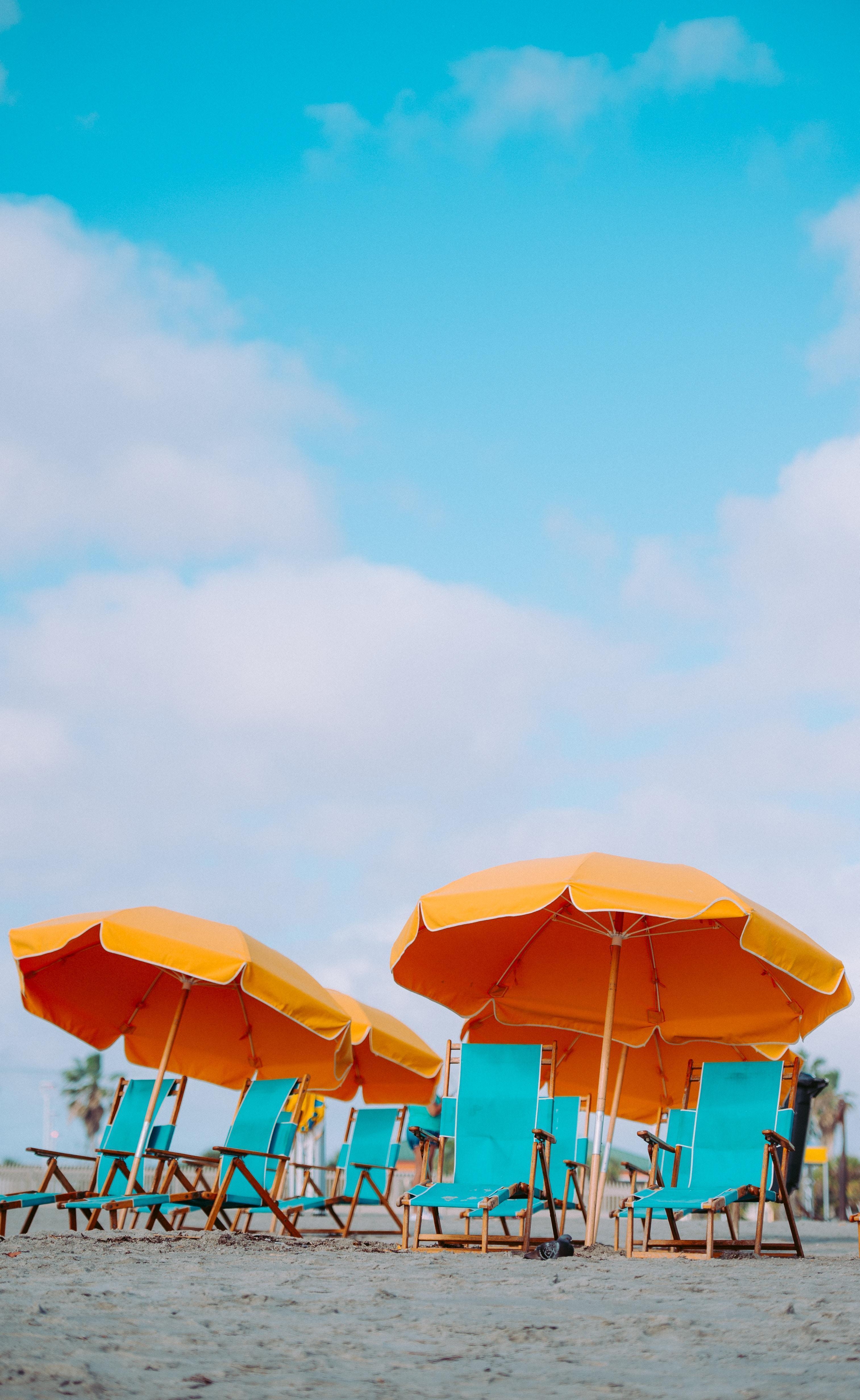 beach chairs with orange umbrellas